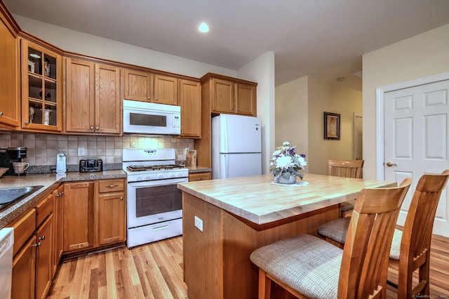 123 Meadow Brook Rd Unit 123, Oxford, CT 06478 - kitchen featuring white appliances, light wood-style floors, brown cabinets, glass insert cabinets, and butcher block counters