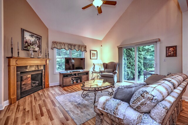 123 Meadow Brook Rd Unit 123, Oxford, CT 06478 - living area featuring high vaulted ceiling, light wood-style floors, a ceiling fan, and a glass covered fireplace