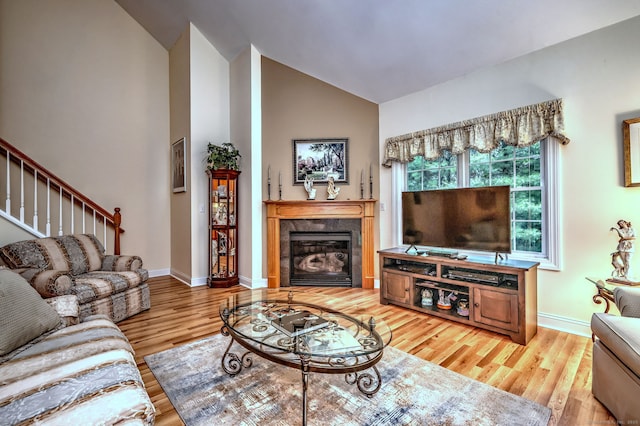 123 Meadow Brook Rd Unit 123, Oxford, CT 06478 - living room with wood finished floors, a tile fireplace, high vaulted ceiling, and stairs