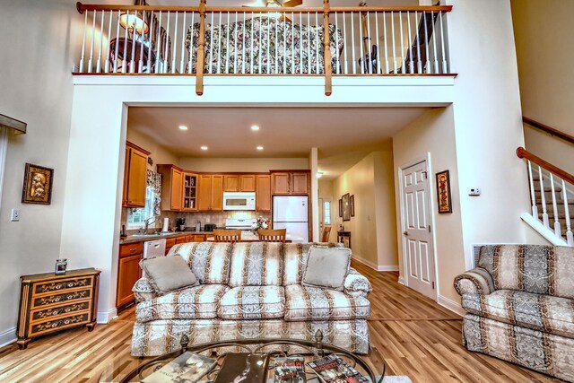 123 Meadow Brook Rd Unit 123, Oxford, CT 06478 - living room with light wood-style flooring, a high ceiling, stairs, and recessed lighting