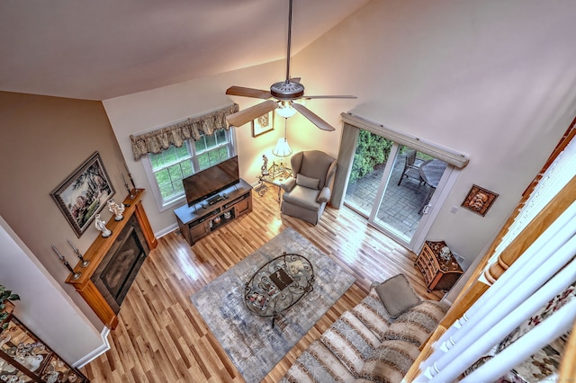 123 Meadow Brook Rd Unit 123, Oxford, CT 06478 - living area featuring light wood finished floors, a ceiling fan, a glass covered fireplace, and high vaulted ceiling