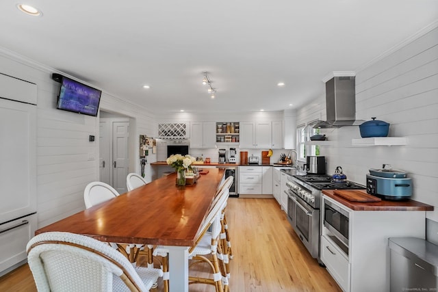 185 Lovers Ln, Fairfield, CT 06824 - kitchen with range hood, open shelves, butcher block counters, white cabinets, and beverage cooler