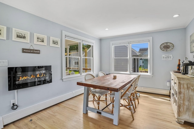 185 Lovers Ln, Fairfield, CT 06824 - dining space with a baseboard heating unit, crown molding, light wood-type flooring, a glass covered fireplace, and recessed lighting