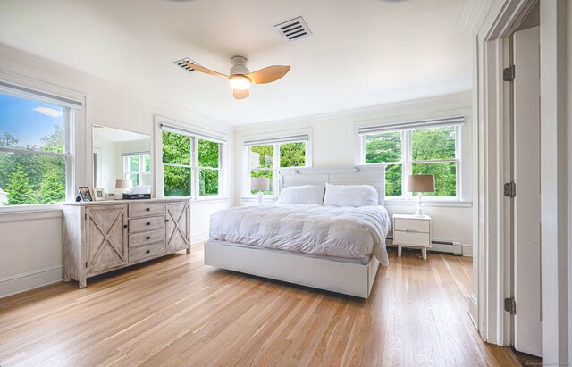 185 Lovers Ln, Fairfield, CT 06824 - bedroom with baseboard heating, light wood-style floors, multiple windows, ornamental molding, and ceiling fan