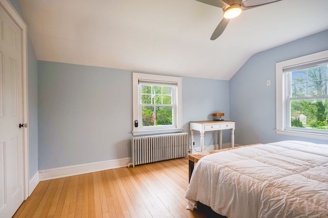 185 Lovers Ln, Fairfield, CT 06824 - bedroom with radiator, vaulted ceiling, hardwood / wood-style floors, multiple windows, and ceiling fan