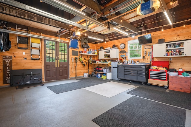 185 Lovers Ln, Fairfield, CT 06824 - garage with a workshop area, wood walls, and a garage door opener