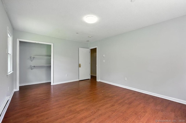 26 Paula Rd, East Haddam, CT 06423 - unfurnished bedroom with a baseboard radiator, wood finished floors, a closet, and a textured ceiling