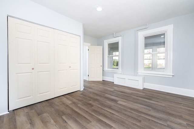 57 Wilson St, New Britain, CT 06051 - unfurnished bedroom featuring dark wood finished floors, baseboards, a closet, and recessed lighting