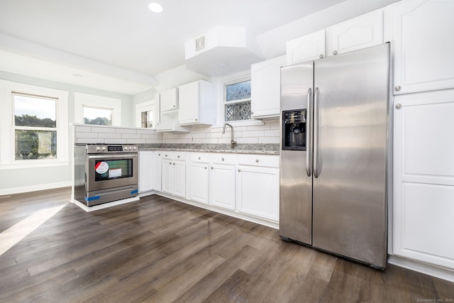57 Wilson St, New Britain, CT 06051 - kitchen with appliances with stainless steel finishes, white cabinetry, dark wood-style floors, and recessed lighting