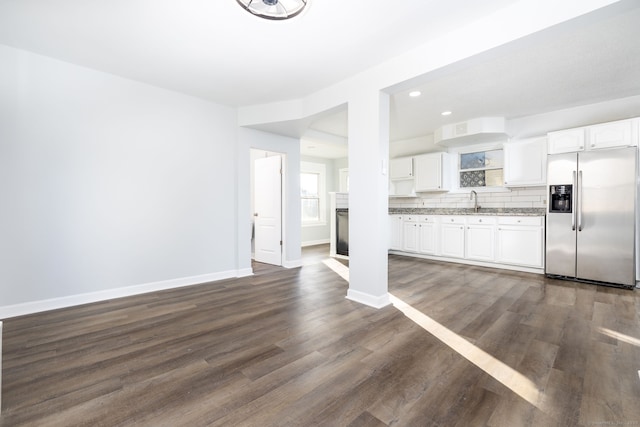57 Wilson St, New Britain, CT 06051 - kitchen with stainless steel fridge, white cabinets, decorative backsplash, baseboards, and recessed lighting