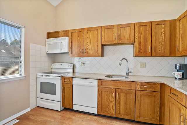 2437 Bedford St Unit E5, Stamford, CT 06905 - kitchen with white appliances, a sink, and brown cabinets