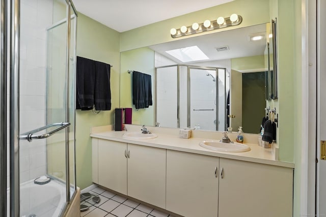 2437 Bedford St Unit E5, Stamford, CT 06905 - bathroom with a skylight, a shower stall, double vanity, and tile patterned floors