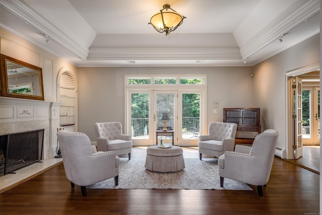 15 NE Rd, Farmington, CT 06032 - living area with ornamental molding, wood finished floors, vaulted ceiling, a tray ceiling, and a fireplace