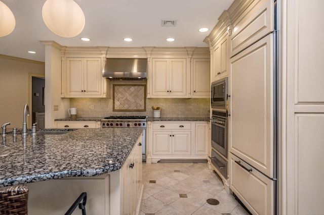 15 NE Rd, Farmington, CT 06032 - kitchen with built in appliances, wall chimney exhaust hood, backsplash, light tile patterned flooring, and dark stone counters