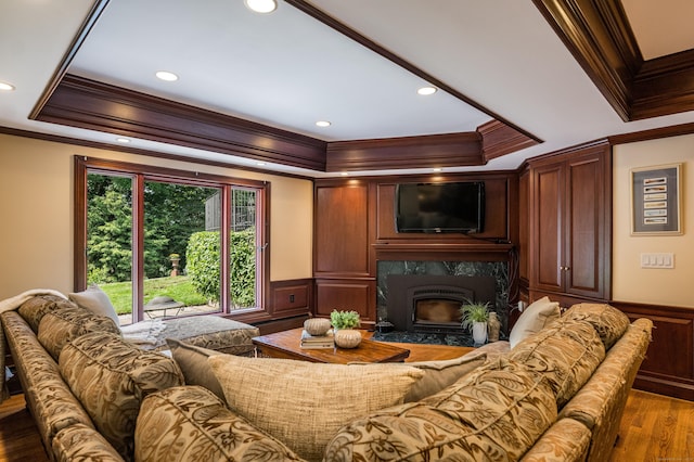 15 NE Rd, Farmington, CT 06032 - living area with crown molding, a wainscoted wall, a high end fireplace, a tray ceiling, and wood finished floors