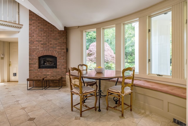 15 NE Rd, Farmington, CT 06032 - dining area featuring a fireplace, beam ceiling, and light tile patterned floors