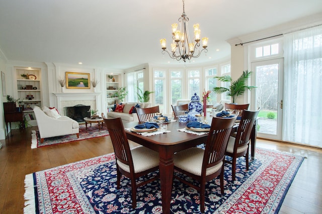 3 Ridgebury Rd, Simsbury, CT 06001 - dining room with a chandelier, wood finished floors, built in shelves, a fireplace, and recessed lighting