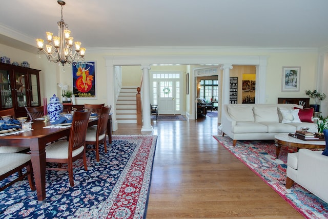 3 Ridgebury Rd, Simsbury, CT 06001 - dining area featuring crown molding, ornate columns, light wood-style flooring, a chandelier, and stairway