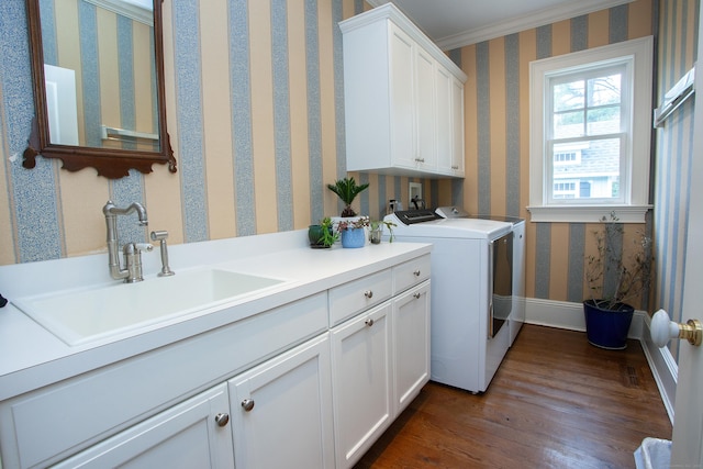 3 Ridgebury Rd, Simsbury, CT 06001 - laundry area with cabinet space, independent washer and dryer, dark wood-style floors, wallpapered walls, and baseboards