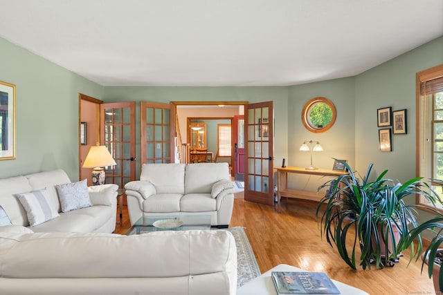 101 Overton Farm Dr, Southbury, CT 06488 - living room with french doors, plenty of natural light, and wood finished floors