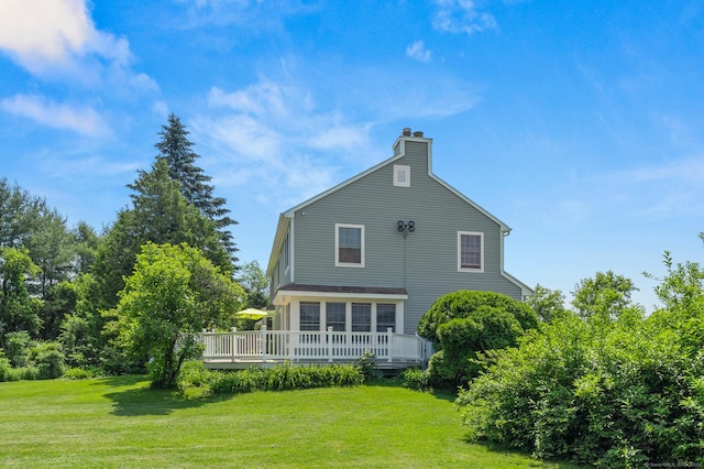 101 Overton Farm Dr, Southbury, CT 06488 - back of property with a deck, a lawn, and a chimney