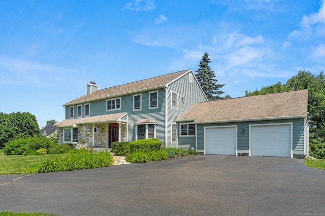 101 Overton Farm Dr, Southbury, CT 06488 - colonial-style house with asphalt driveway, a garage, and a chimney