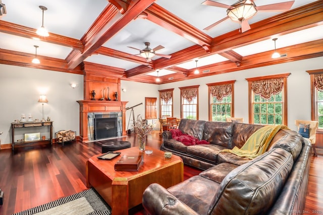 living area featuring a ceiling fan, wood finished floors, a tiled fireplace, beamed ceiling, and coffered ceiling