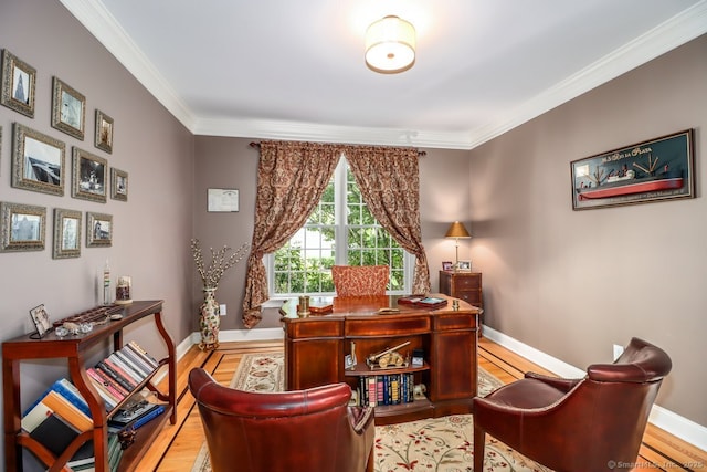 office space with crown molding, light wood finished floors, and baseboards