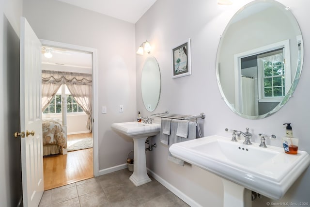 bathroom with tile patterned flooring, baseboards, and a sink