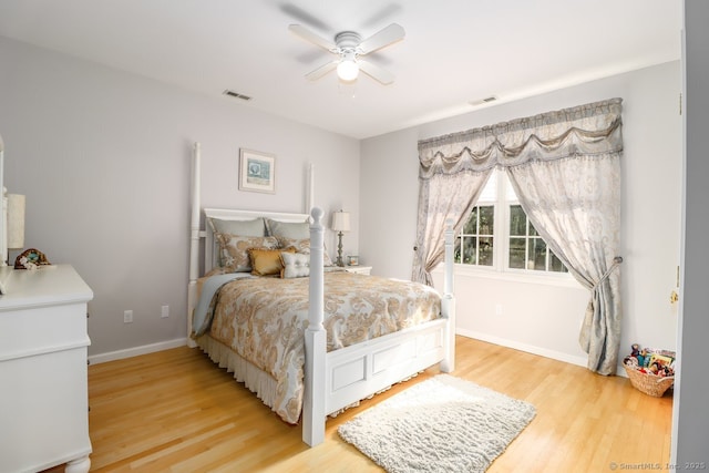 bedroom featuring light wood-type flooring, baseboards, and ceiling fan