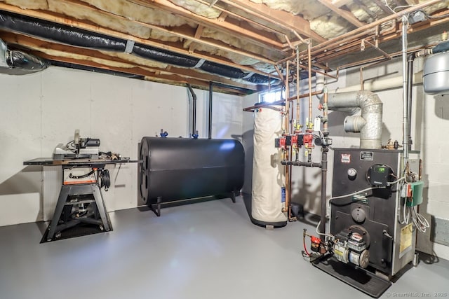 unfinished below grade area with oil tank and a heating unit
