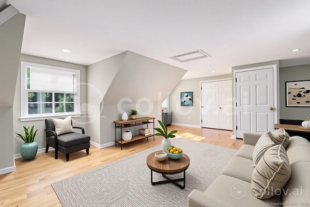 living area featuring light wood-type flooring, baseboards, and recessed lighting