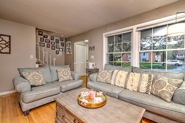 39 Jackson Dr Unit 39, Milford, CT 06460 - living area with light wood-type flooring, stairs, healthy amount of natural light, and baseboards