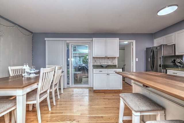 39 Jackson Dr Unit 39, Milford, CT 06460 - kitchen featuring freestanding refrigerator, light wood finished floors, butcher block counters, backsplash, and white cabinetry