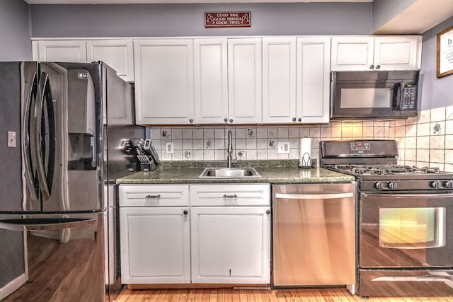 39 Jackson Dr Unit 39, Milford, CT 06460 - kitchen with black appliances, a sink, dark countertops, and white cabinets