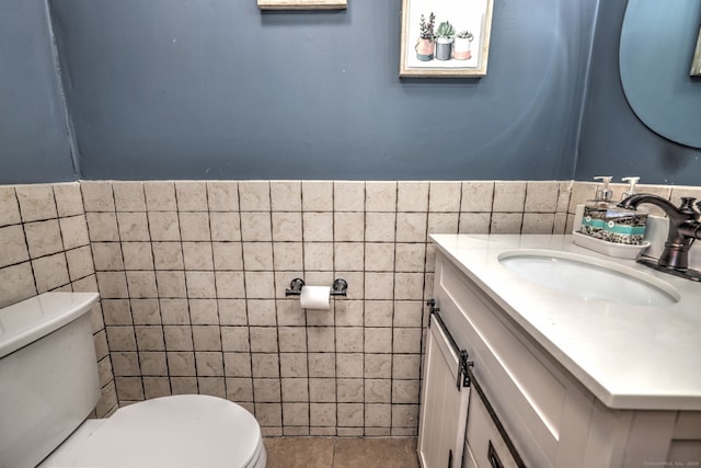 39 Jackson Dr Unit 39, Milford, CT 06460 - bathroom with tile walls, toilet, vanity, and a wainscoted wall