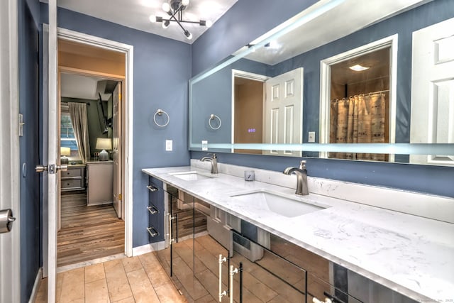 39 Jackson Dr Unit 39, Milford, CT 06460 - bathroom featuring double vanity, wood finished floors, and baseboards