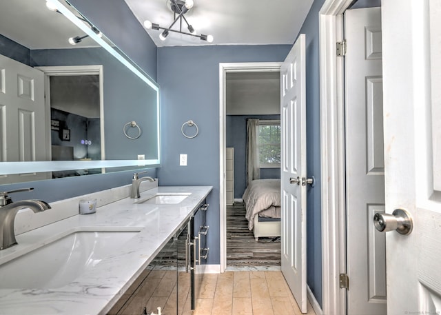 39 Jackson Dr Unit 39, Milford, CT 06460 - ensuite bathroom with double vanity, wood finished floors, and baseboards