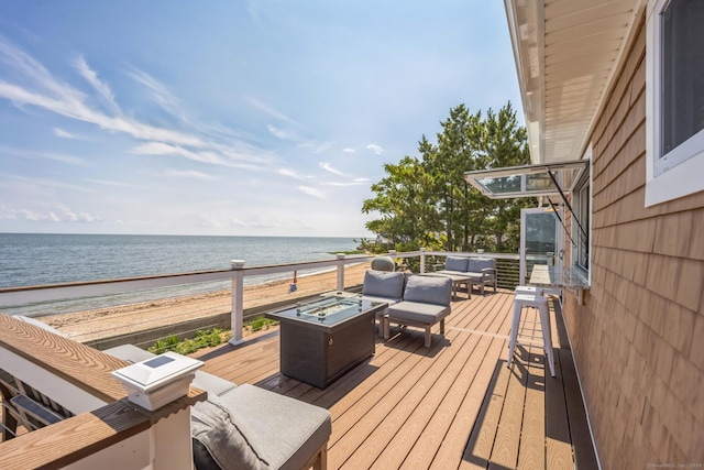 74 Morgan Ave, East Haven, CT 06512 - wooden terrace with view of water and beach and an outdoor living space with a fire pit