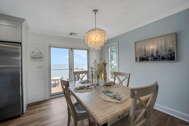 74 Morgan Ave, East Haven, CT 06512 - dining space with a chandelier, ornamental molding, a water view, dark wood-style flooring, and baseboards