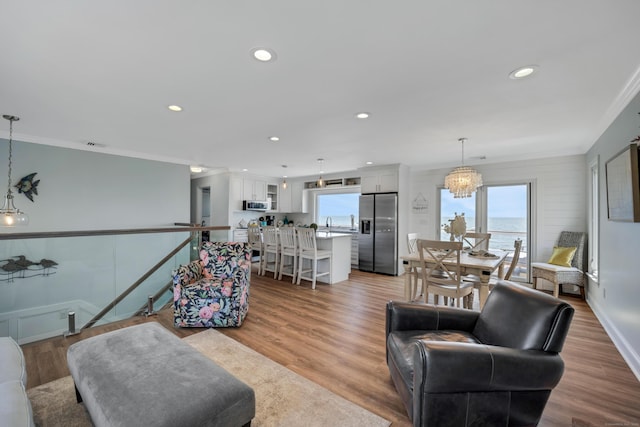 74 Morgan Ave, East Haven, CT 06512 - living area featuring ornamental molding, recessed lighting, wood finished floors, baseboards, and a chandelier