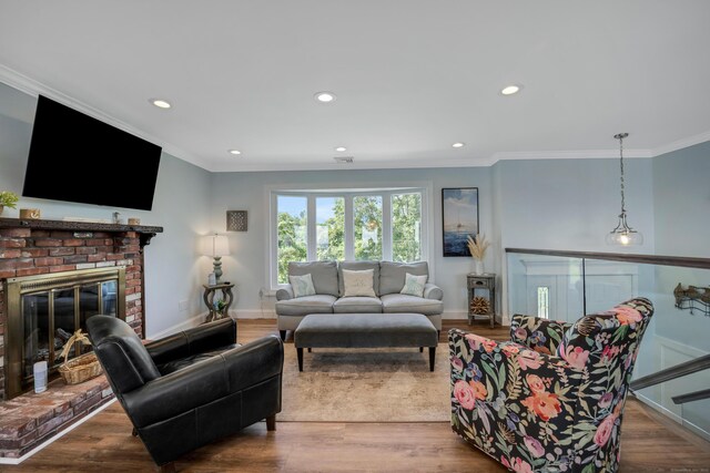 74 Morgan Ave, East Haven, CT 06512 - living room featuring crown molding, recessed lighting, baseboards, a fireplace, and wood finished floors