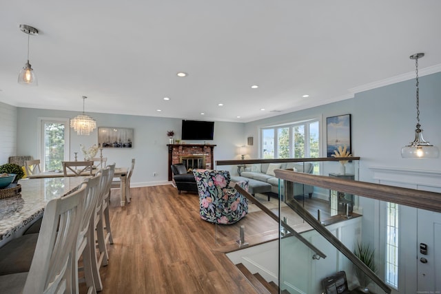 74 Morgan Ave, East Haven, CT 06512 - living room with wood finished floors, plenty of natural light, a brick fireplace, recessed lighting, and crown molding