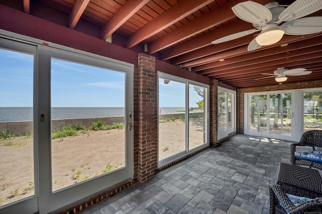 74 Morgan Ave, East Haven, CT 06512 - unfurnished sunroom featuring view of water and beach, a ceiling fan, beamed ceiling, and healthy amount of natural light