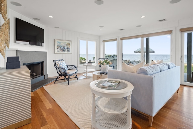 685 Fairfield Beach Rd Unit 685, Fairfield, CT 06824 - living room featuring a water view, wood finished floors, a fireplace, and recessed lighting