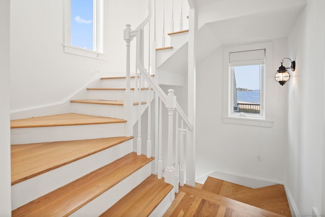 685 Fairfield Beach Rd Unit 685, Fairfield, CT 06824 - stairs with baseboards, a water view, and wood finished floors