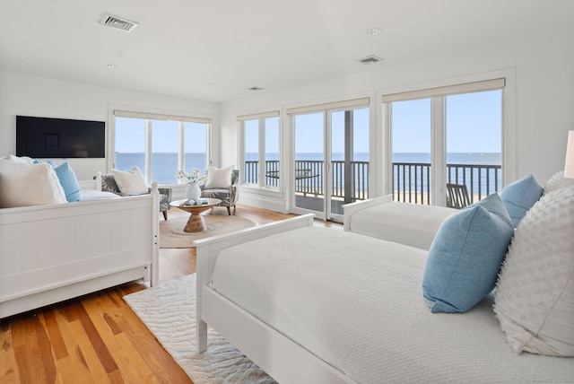 685 Fairfield Beach Rd Unit 685, Fairfield, CT 06824 - bedroom featuring access to exterior, a water view, and wood finished floors