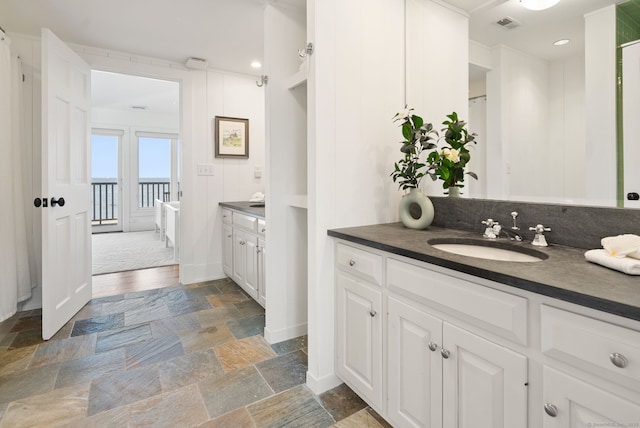 685 Fairfield Beach Rd Unit 685, Fairfield, CT 06824 - bathroom featuring vanity, stone tile flooring, and recessed lighting