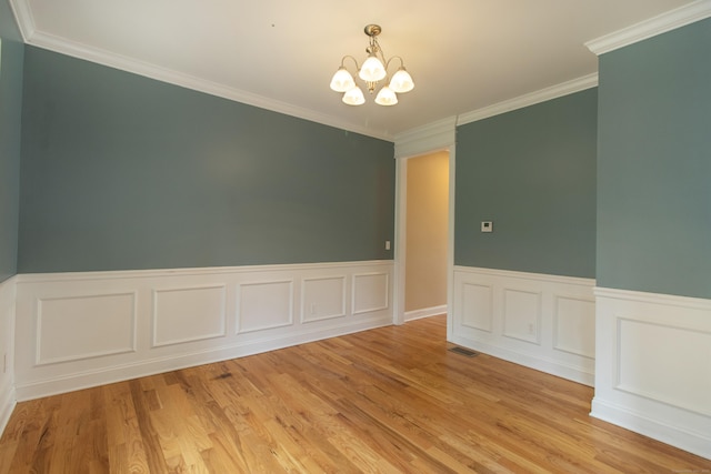 1705 Orchard Rd, Berlin, CT 06037 - spare room featuring a chandelier, a wainscoted wall, light wood-style floors, and crown molding