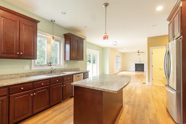 1705 Orchard Rd, Berlin, CT 06037 - kitchen with freestanding refrigerator, open floor plan, decorative light fixtures, a center island, and light wood-style flooring